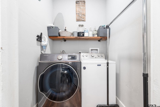 laundry room featuring hardwood / wood-style floors and washer and clothes dryer