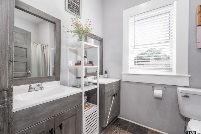 bathroom featuring vanity, toilet, and a shower with curtain