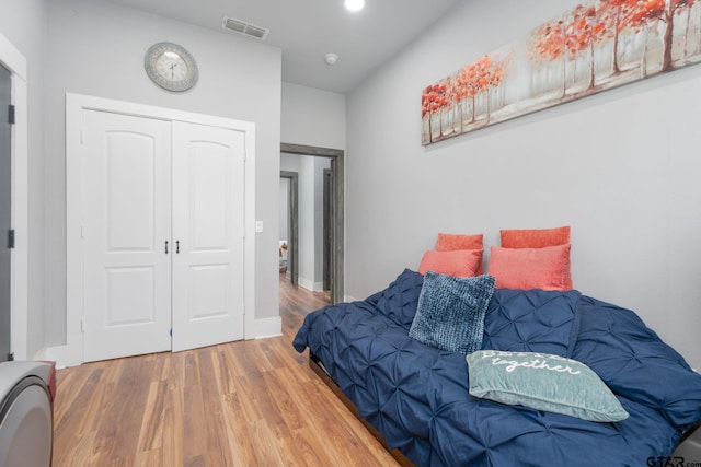 bedroom featuring wood-type flooring and a closet