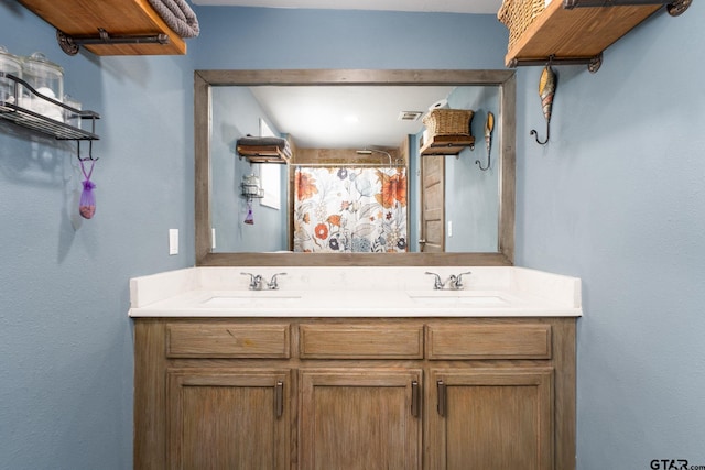 bathroom featuring a shower with curtain and vanity