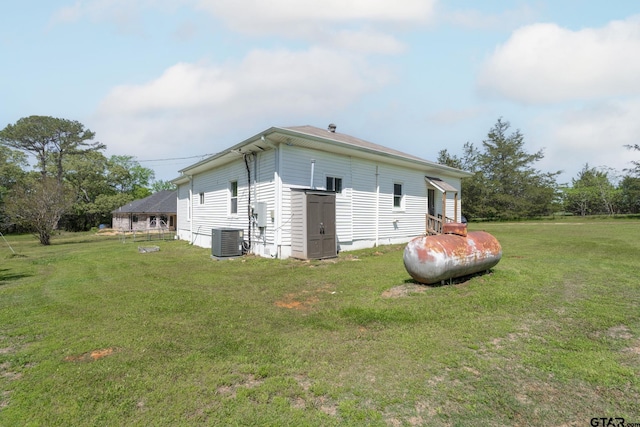 view of home's exterior featuring a lawn and central AC