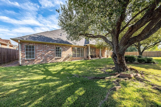 back of house with a patio and a yard