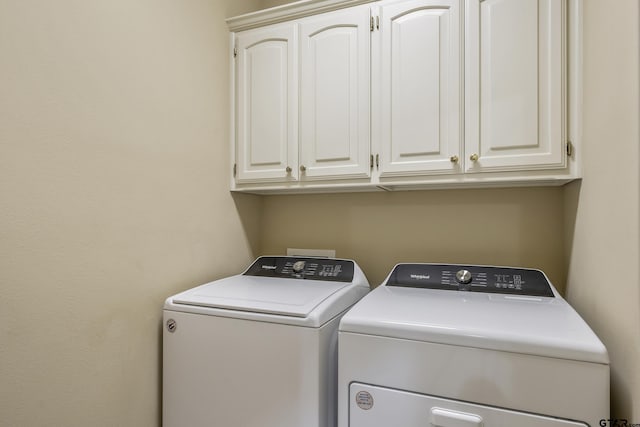 washroom featuring cabinets and washer and dryer