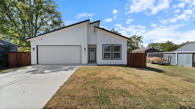 view of front of home with a front lawn and a garage