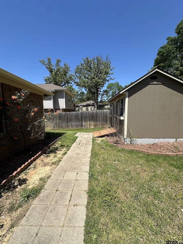 view of yard with an outbuilding and fence