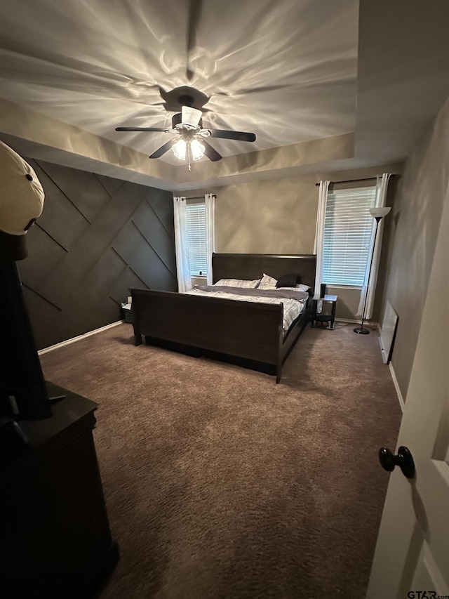 bedroom featuring ceiling fan, carpet, and baseboards