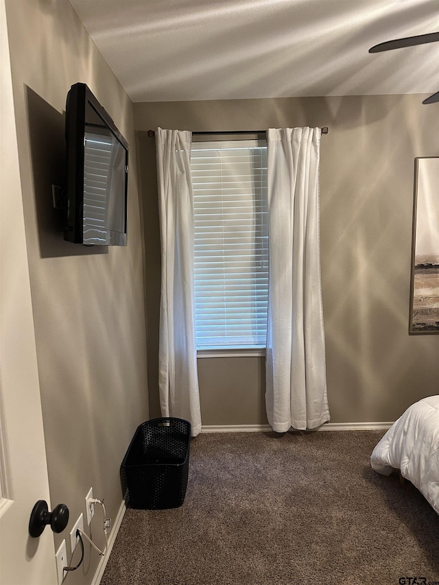 bedroom with ceiling fan, baseboards, and carpet floors
