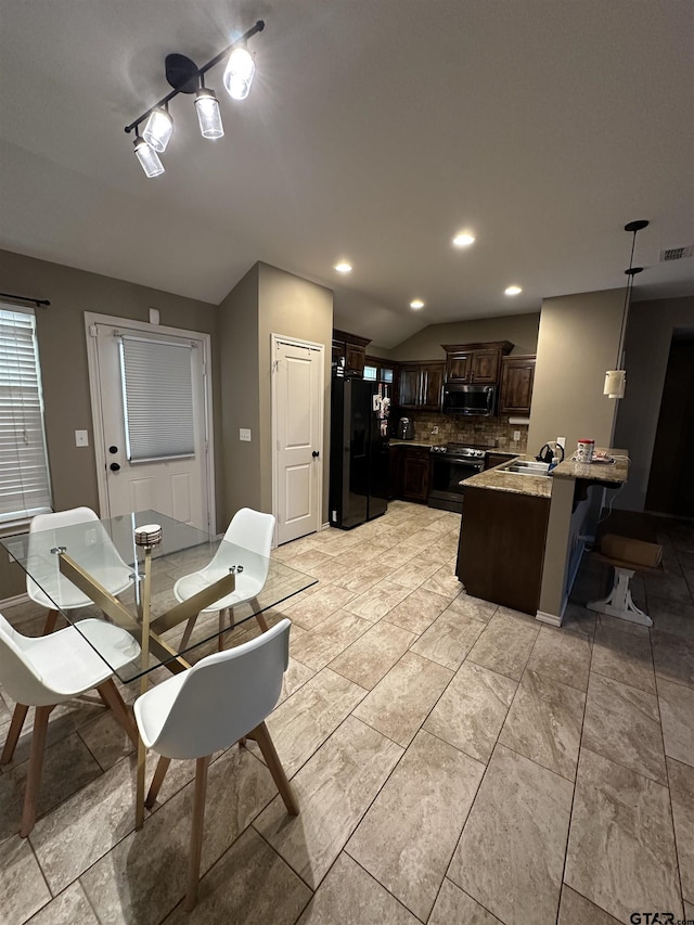 kitchen with tasteful backsplash, visible vents, stainless steel appliances, dark brown cabinets, and a peninsula