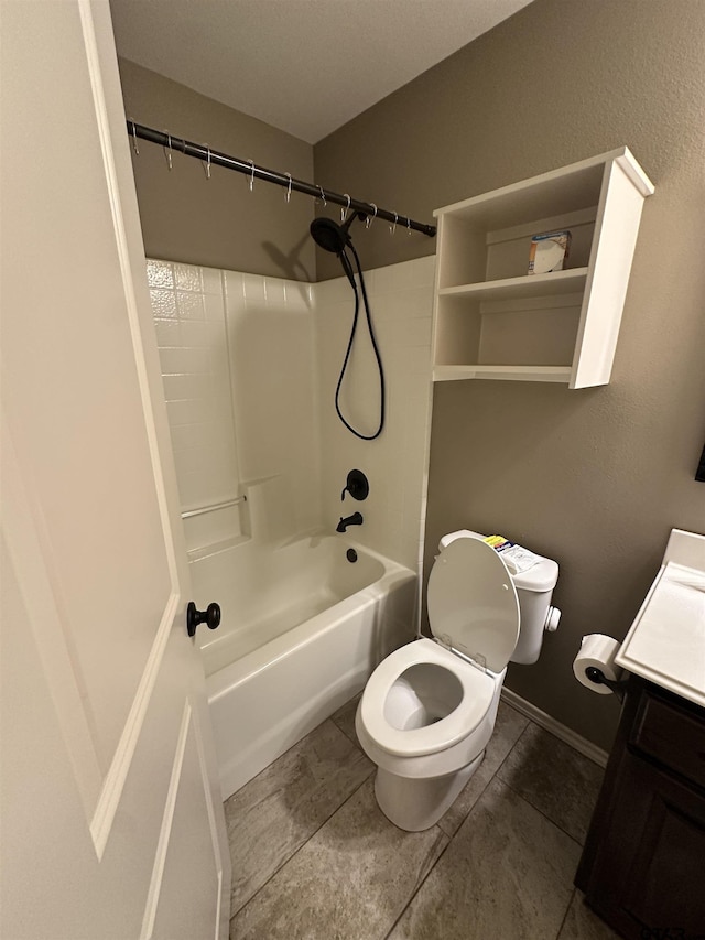 bathroom featuring vanity, bathing tub / shower combination, tile patterned floors, toilet, and baseboards