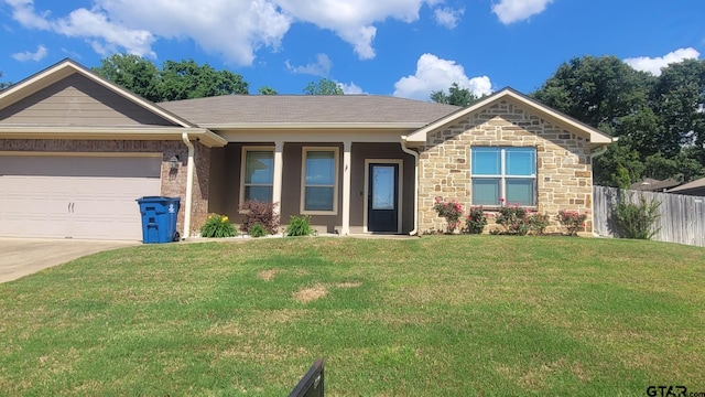 409 Mission Crest Cir, Lindale, TX 75771 - view of front of property with driveway, stone siding, and a garage