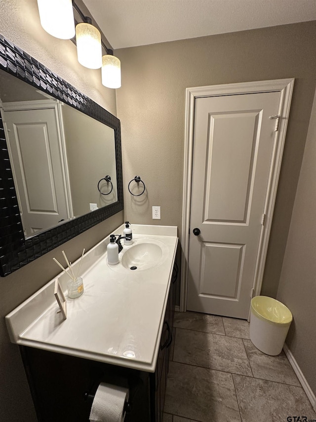 bathroom featuring vanity and baseboards
