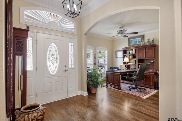 265 Bunker Dr, Tyler, TX 75703 - foyer entrance featuring crown molding, dark wood-style flooring, ceiling fan, arched walkways, and a chandelier