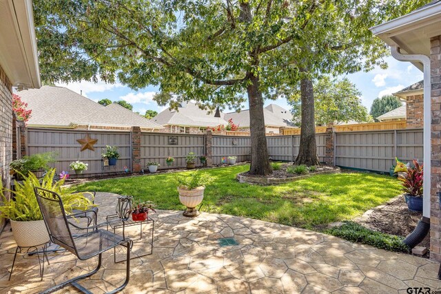265 Bunker Dr, Tyler, TX 75703 - fenced backyard featuring a patio area