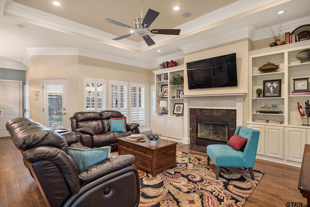 265 Bunker Dr, Tyler, TX 75703 - living room with a fireplace, wood finished floors, ceiling fan, a tray ceiling, and recessed lighting
