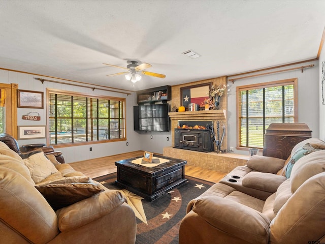 living room featuring a textured ceiling, wood-type flooring, and ceiling fan