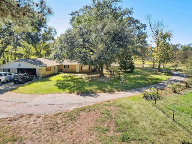 view of front of house with a garage and a front lawn