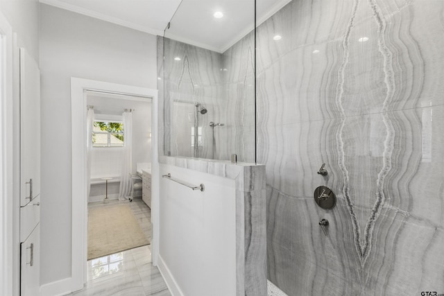 bathroom with tiled shower and crown molding