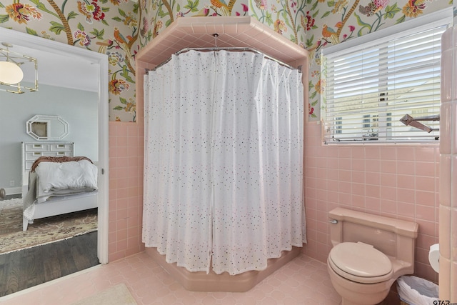 bathroom with tile patterned flooring, a shower with shower curtain, tile walls, and toilet