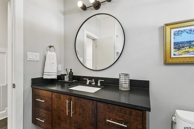 bathroom featuring vanity and toilet