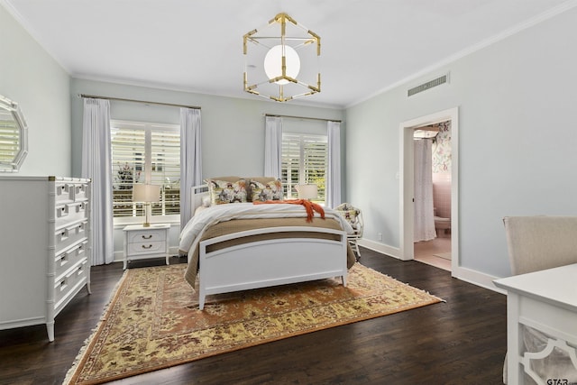 bedroom with connected bathroom, ornamental molding, dark wood-type flooring, and a notable chandelier