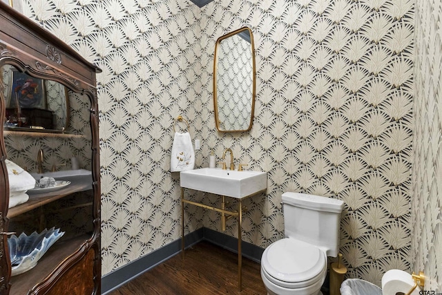 bathroom featuring hardwood / wood-style floors and toilet