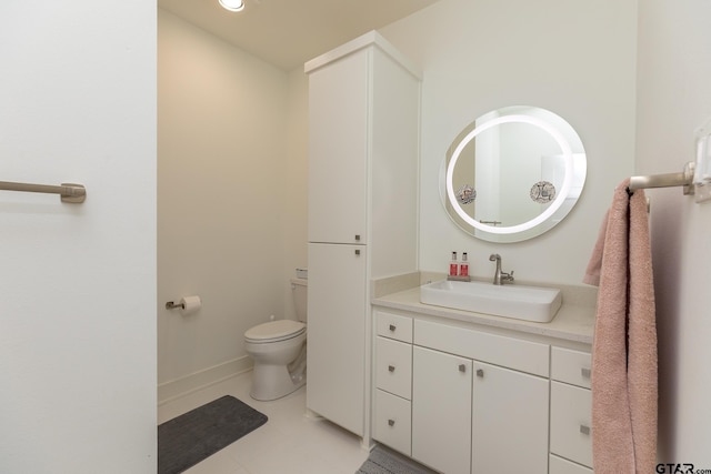 bathroom with vanity, toilet, and tile patterned flooring