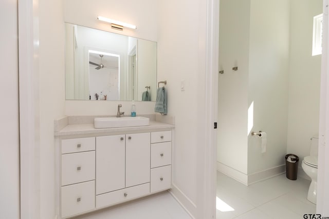 bathroom featuring vanity, tile patterned floors, and toilet