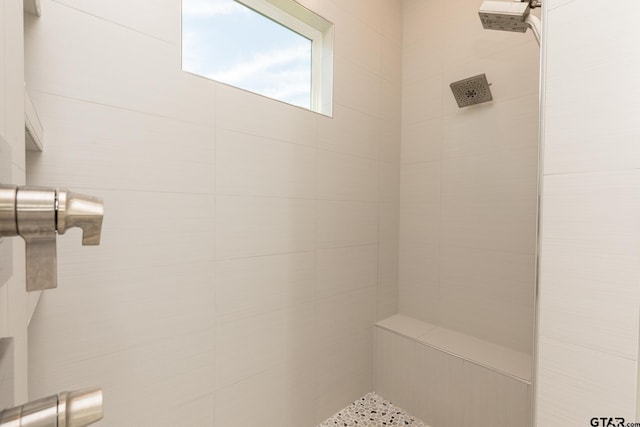 bathroom with tiled shower