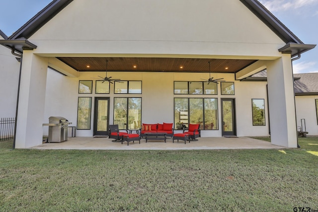 back of property featuring an outdoor living space, a lawn, a patio, and ceiling fan