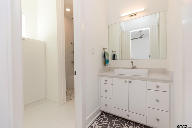 bathroom with vanity, a shower, and tile patterned floors