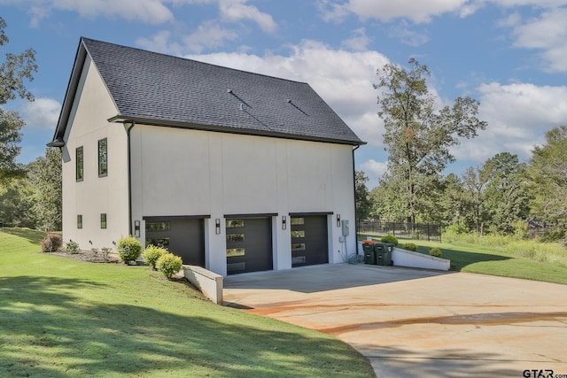 view of side of property with a yard and a garage