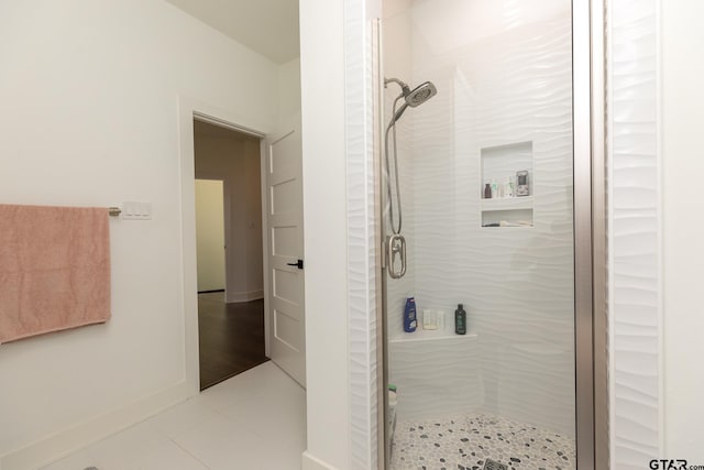 bathroom featuring tile patterned flooring and a shower with door