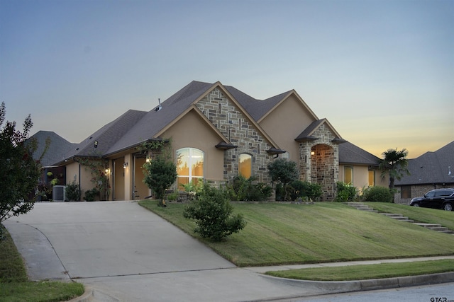 french provincial home with a lawn and cooling unit