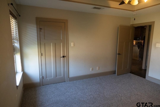 unfurnished bedroom featuring carpet floors and ceiling fan