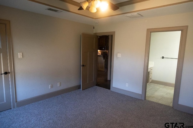 unfurnished bedroom with light carpet, ensuite bath, and ceiling fan