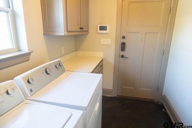 laundry area with washer and clothes dryer and cabinets