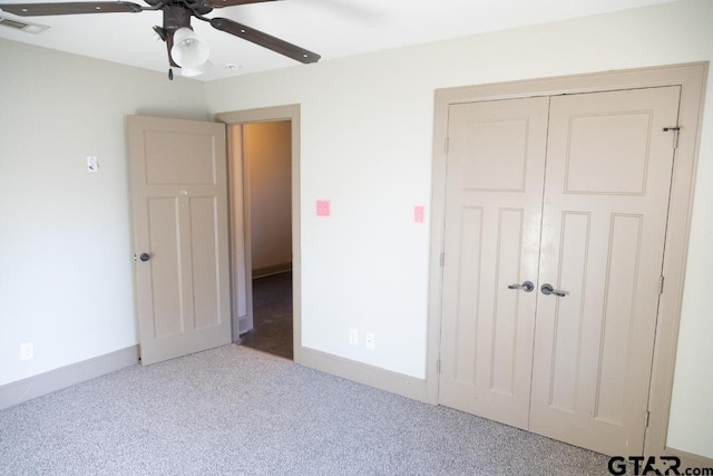 unfurnished bedroom featuring ceiling fan, carpet floors, and a closet