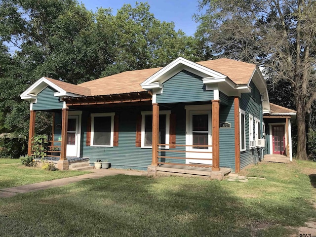 bungalow-style home with covered porch and a front lawn