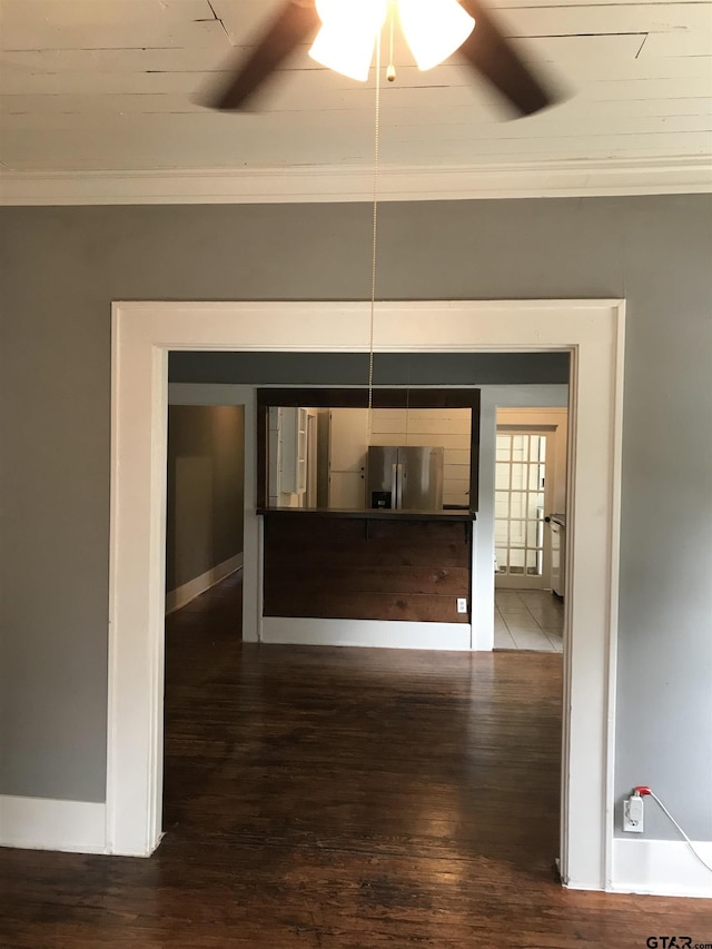 interior space with dark hardwood / wood-style floors and ornamental molding