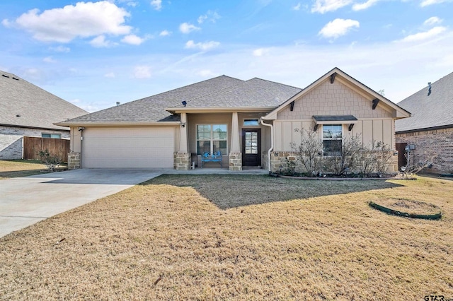 view of front of house featuring a front yard and a garage