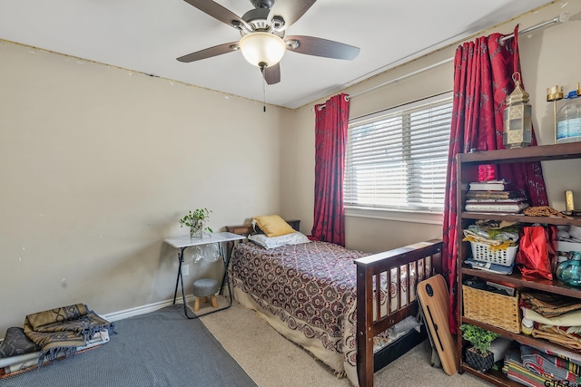 bedroom with ceiling fan and light colored carpet