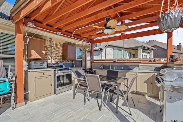 view of patio / terrace with area for grilling, ceiling fan, sink, and grilling area