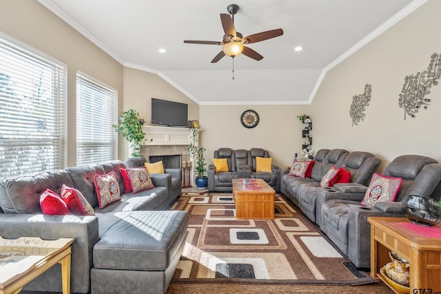 living room featuring vaulted ceiling, ceiling fan, and ornamental molding