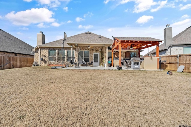 rear view of property with a storage shed, a yard, and a patio