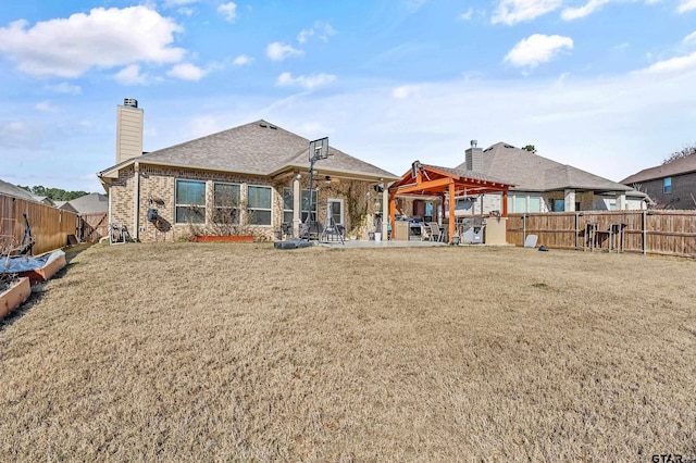 back of house featuring a patio area and a yard