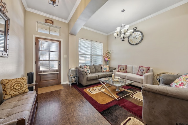 living room featuring dark hardwood / wood-style floors, ornamental molding, and an inviting chandelier