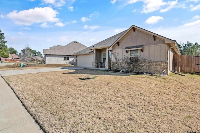 view of front of house featuring a garage and a front lawn