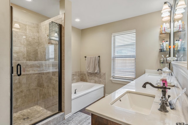 bathroom with separate shower and tub, vanity, and a chandelier