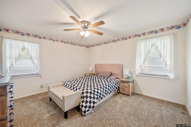 bedroom featuring light carpet, multiple windows, and ceiling fan