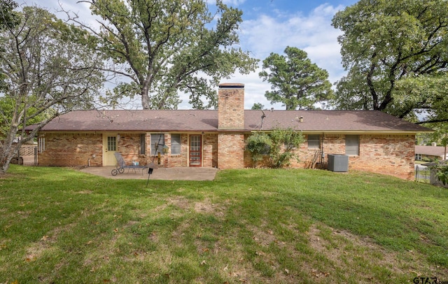 rear view of house with central AC, a patio, and a yard